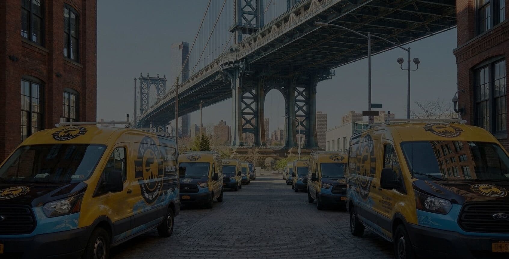 Karl's Plumbing fleet of service vans under the Manhattan Bridge